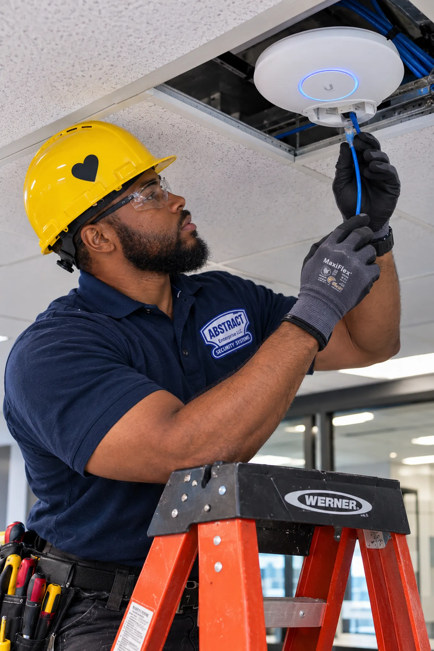 AESS technician reconnecting a Cat6 cable to a ceiling Wi-Fi access point in the Hudson Valley