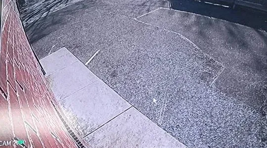 Camera tile with a date stamp along a brick wall โ Bronx Smart PSS clock check example Smart PSS setup Bronx example photo: a single camera tile looking along a brick wall to a paved lot, with a date stamp in the corner of the picture
