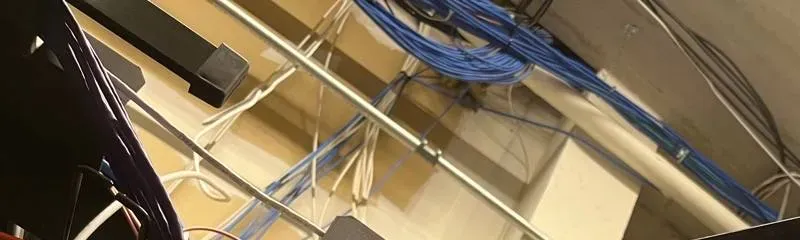 Network cable bundles above a recorder shelf โ Bronx Smart PSS network example Smart PSS support setup Bronx example photo: blue and white network cable bundles running along a ceiling above a recorder shelf