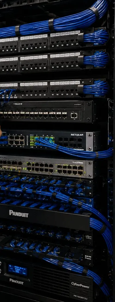 Equipment rack with patch panels, switches and battery backup — Greenwich Village, Manhattan Sonos installation Sonos installation Greenwich Village, Manhattan: a tall black equipment rack with patch panels, network switches laced with blue cables, cable managers and a battery backup unit at the bottom