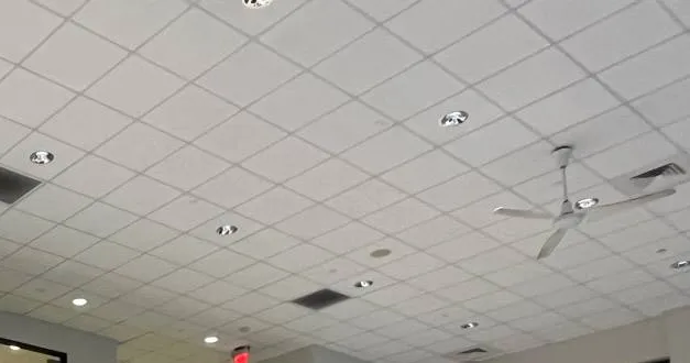 Throgs Neck, Bronx Sonos installation reference photo: high tiled ceiling with recessed lights, vents and a white ceiling fan above a row of upper windows