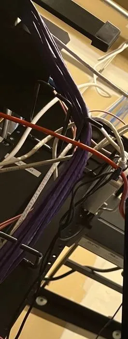 Throgs Neck, Bronx Sonos installation reference photo: purple cable bundle and red and white patch cords dropping down the side of an equipment rack