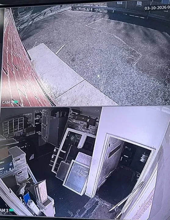 Two-view split screen of a lot and a storeroom — Westchester display layout reference Westchester County video wall reference photo: a screen split into two camera views, a paved lot beside a brick wall above and a cluttered storeroom with a doorway below